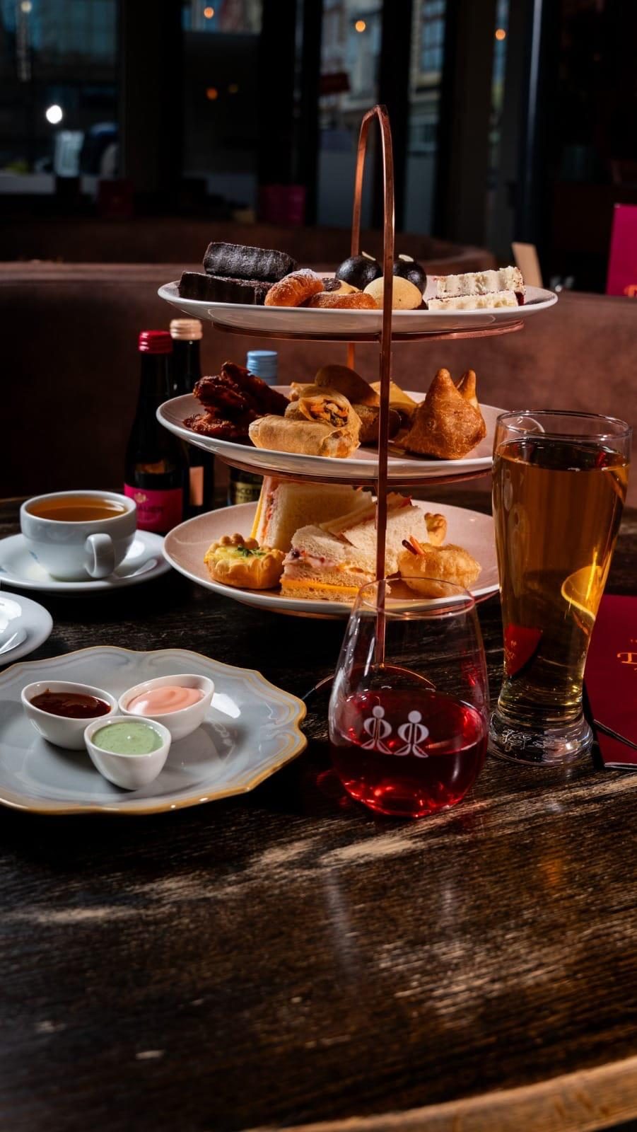 High tea by the window with tea and macarons