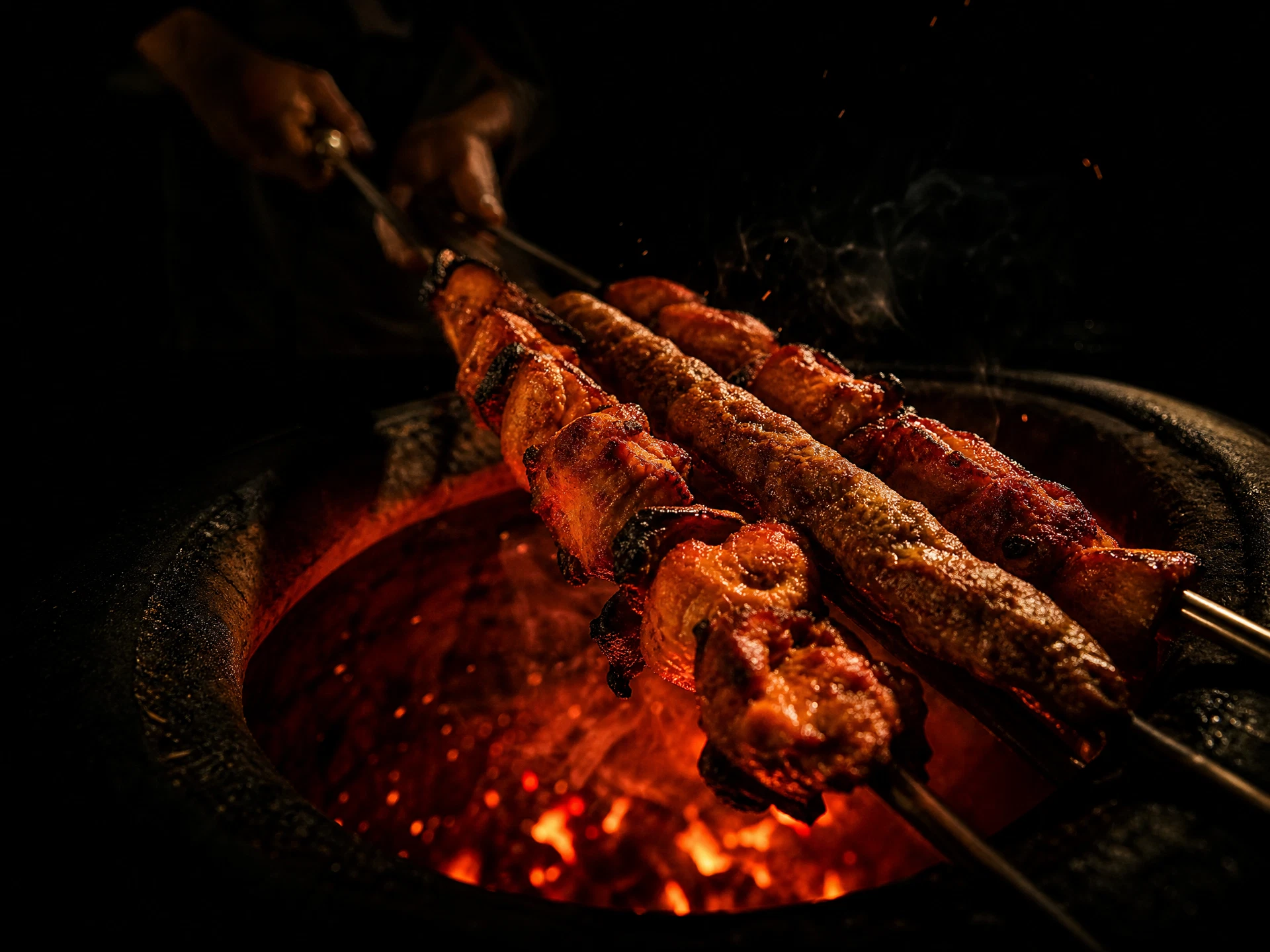 Skewers of tandoori chicken lifted from a glowing clay tandoor